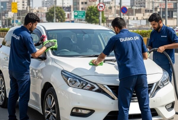 Hyper-realistic image of a white 2021 Nissan Wingroad being detailed by Bulao.pk technicians in navy-blue uniforms on a sunlit Karachi street. One technician polishes the exterior and rims, while another vacuums and sanitizes the interior. Urban Karachi buildings and street signs are visible in the background. The car’s number plate is blank.