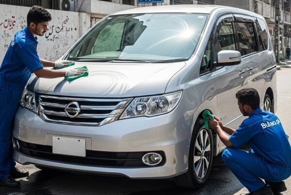 Hyper-realistic image of a silver Nissan Serena MPV being cleaned by two Bulao.pk technicians on a sunlit Karachi street. One technician polishes the car’s hood and panels, while the other cleans the wheels.