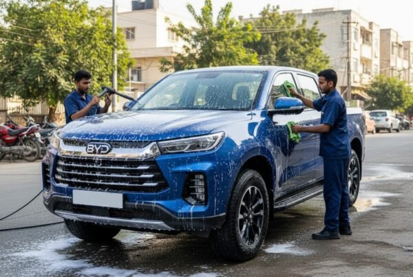 BYD Shark pickup truck cleaning and detailing service in Karachi with technicians washing and polishing for a spotless exterior and showroom finish.