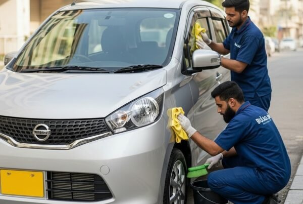 Hyper-realistic image of a silver Nissan Dayz compact hatchback being cleaned by two Bulao.pk technicians on a Karachi street. One polishes the hood and doors while the other cleans the wheels.