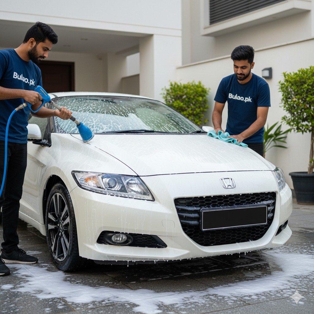 Bulao.pk technicians detailing a pearl white Honda CR-Z in Karachi, applying foam and wiping the hood for a sleek, showroom-like finish.