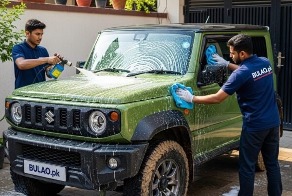 Two Bulao.pk technicians detailing a green Suzuki Jimny in Karachi, removing mud and dirt, showcasing a clean and protected rugged compact SUV.