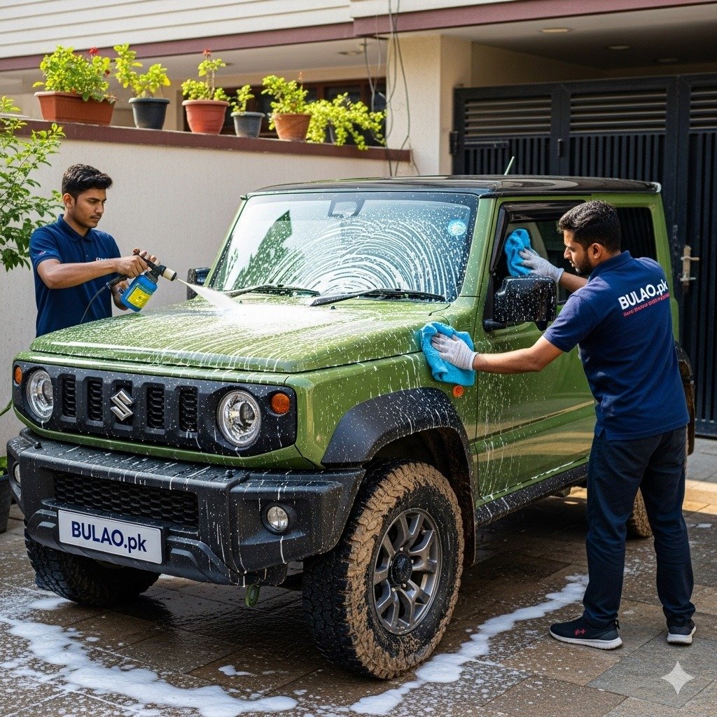 Two Bulao.pk technicians detailing a green Suzuki Jimny in Karachi, removing mud and dirt, showcasing a clean and protected rugged compact SUV.