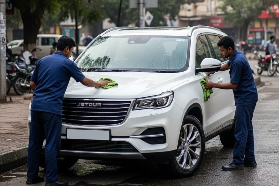 Jetour X90 SUV car cleaning and detailing service in Karachi with technicians polishing exterior and cleaning panels for a spotless finish.
